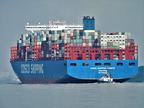 Large cargo ship navigating through Hamburg's waters, laden with shipping containers.