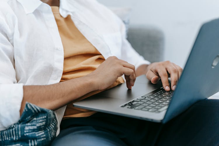 Crop Remote Employee Typing On Laptop At Home