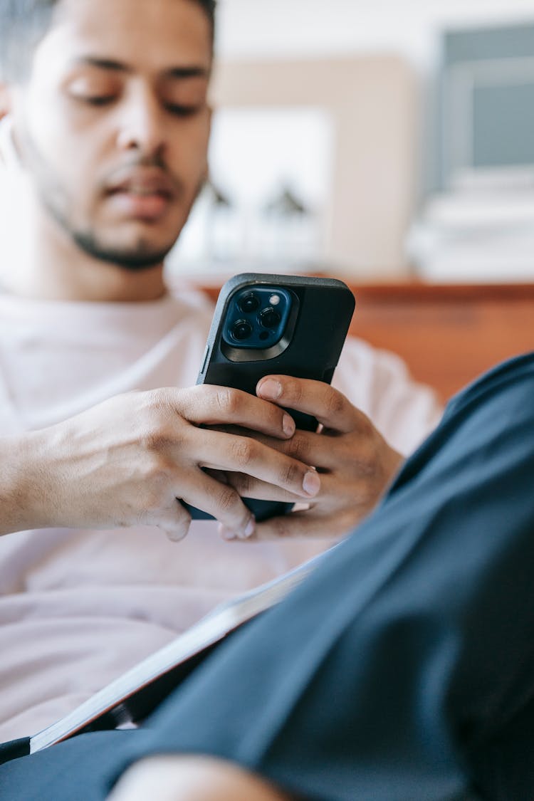 Serious Indian Man Browsing Smartphone