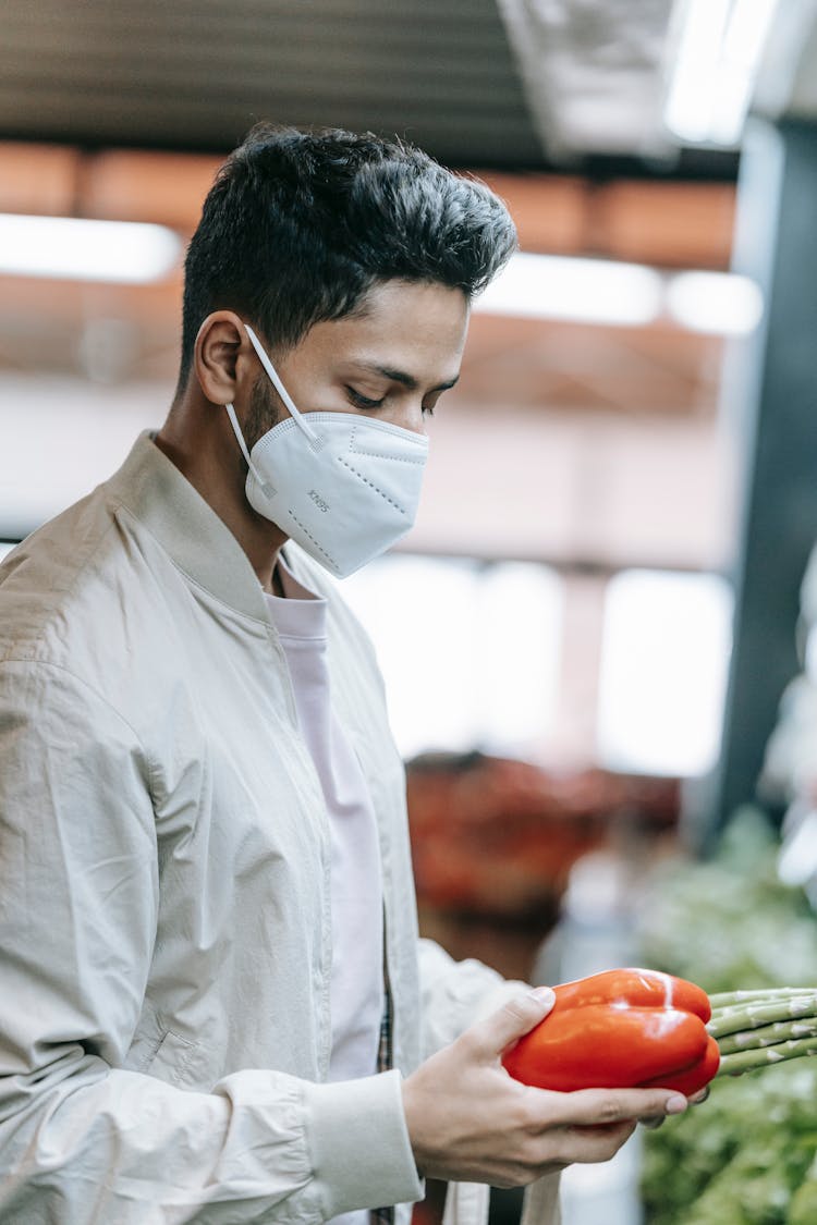 Indian Man In Protective Mask Choosing Vegetables In Supermarket