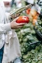 Unrecognizable customer choosing vegetables in supermarket