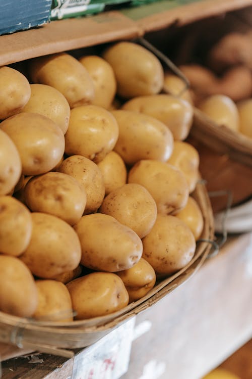 Free Basket with fresh potatoes placed on counter in market Stock Photo