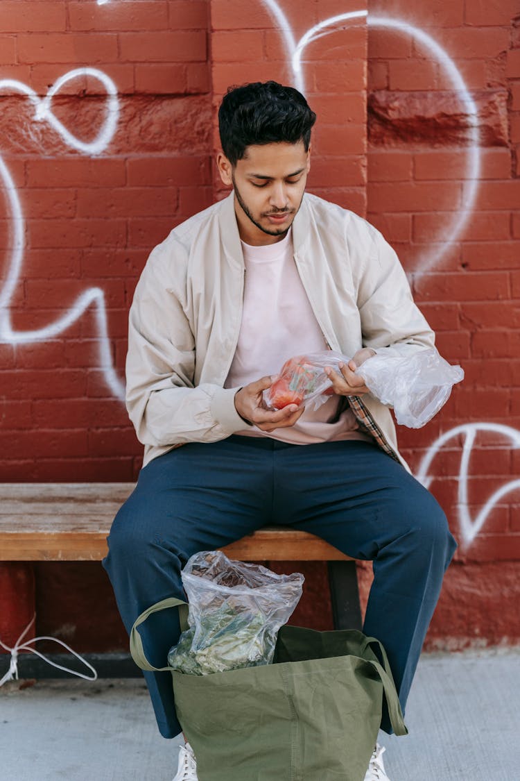 Stylish Indian Man With Cellophane Bag Of Tomatoes In Town