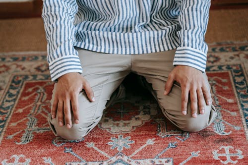 Man Kneeling on The Rug