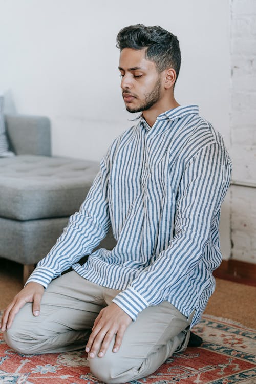 Man Kneeling on The Rug