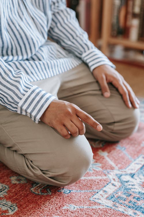 Man Kneeling on The Rug