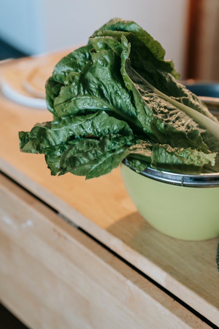 Spinach Leaves In Bowl On Table In Kitchen