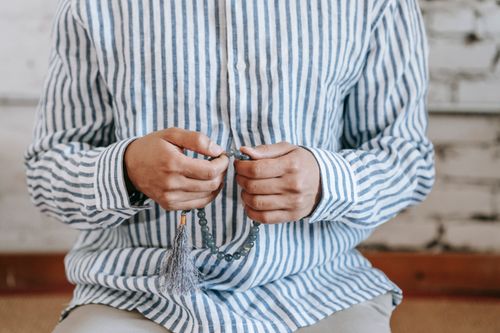 Man Praying with Prayer Beads · Free Stock Photo