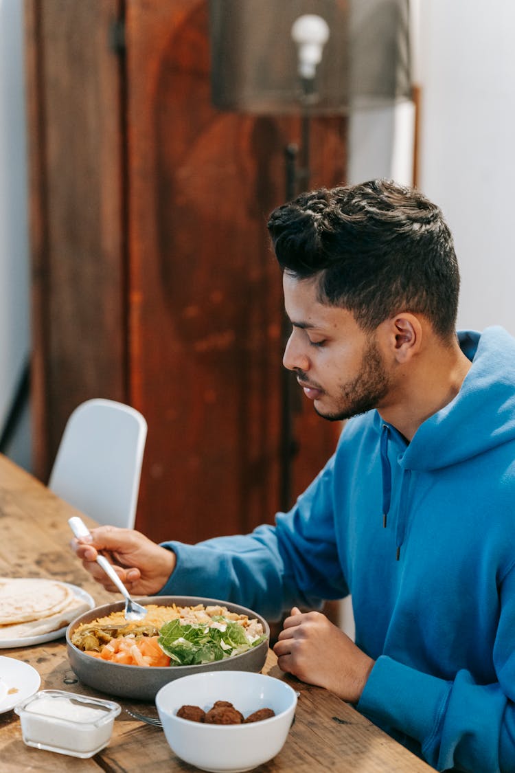 Indian Man At Table With Delicious Lunch In House