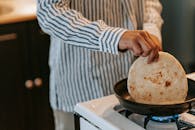 Man cooking pancake in kitchen