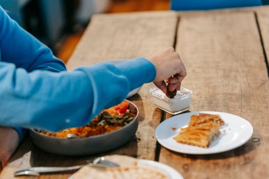 Man having supper with tasty dish and baklava