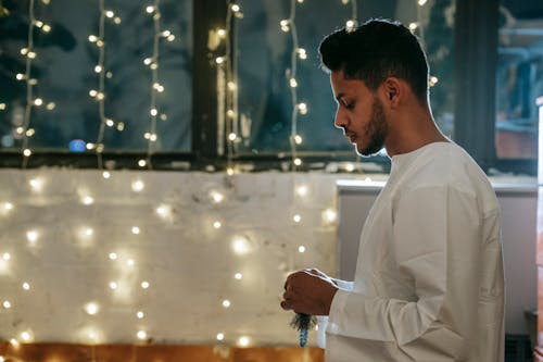 Man Praying with Prayer Beads