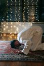 Man in White Thobe Bowing Down on Red and Blue Rug