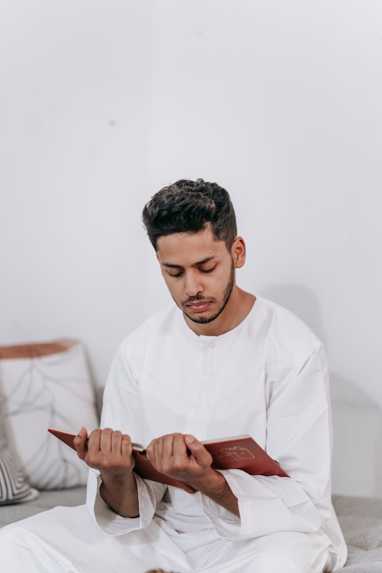 Person Holding A Quran