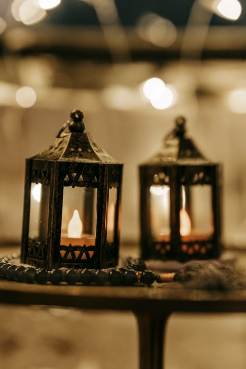 Free Small plastic decorative candles placed in metal candleholders against blurred background in room Stock Photo