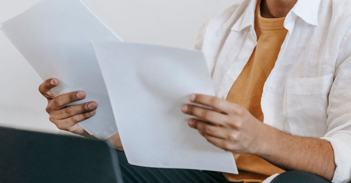 Reading.doc Man reading documents at workplace · Free Stock Photo
