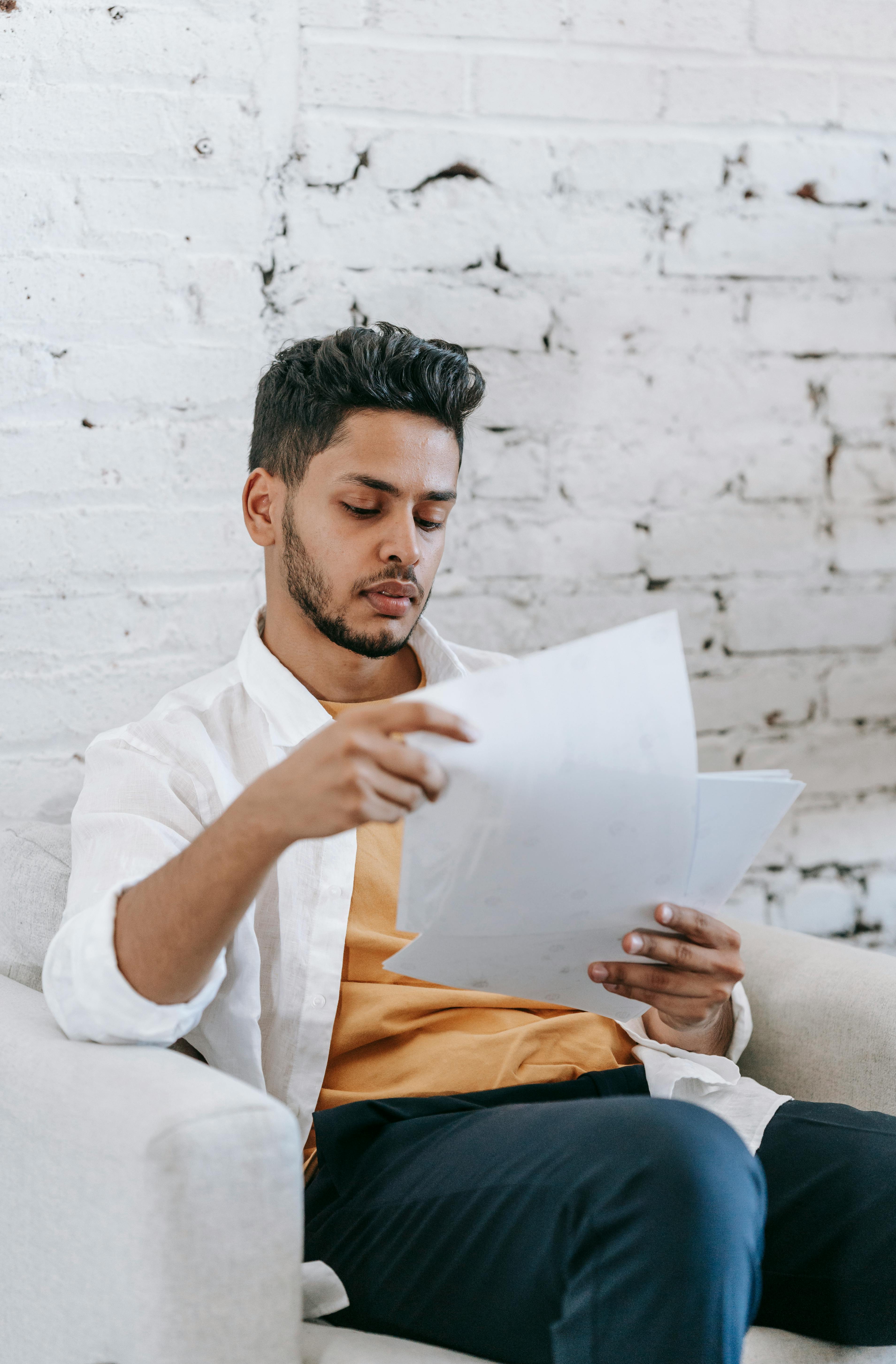 serious young man examining documents