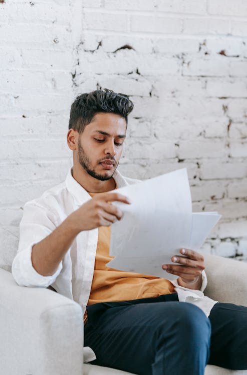 Serious young man examining documents