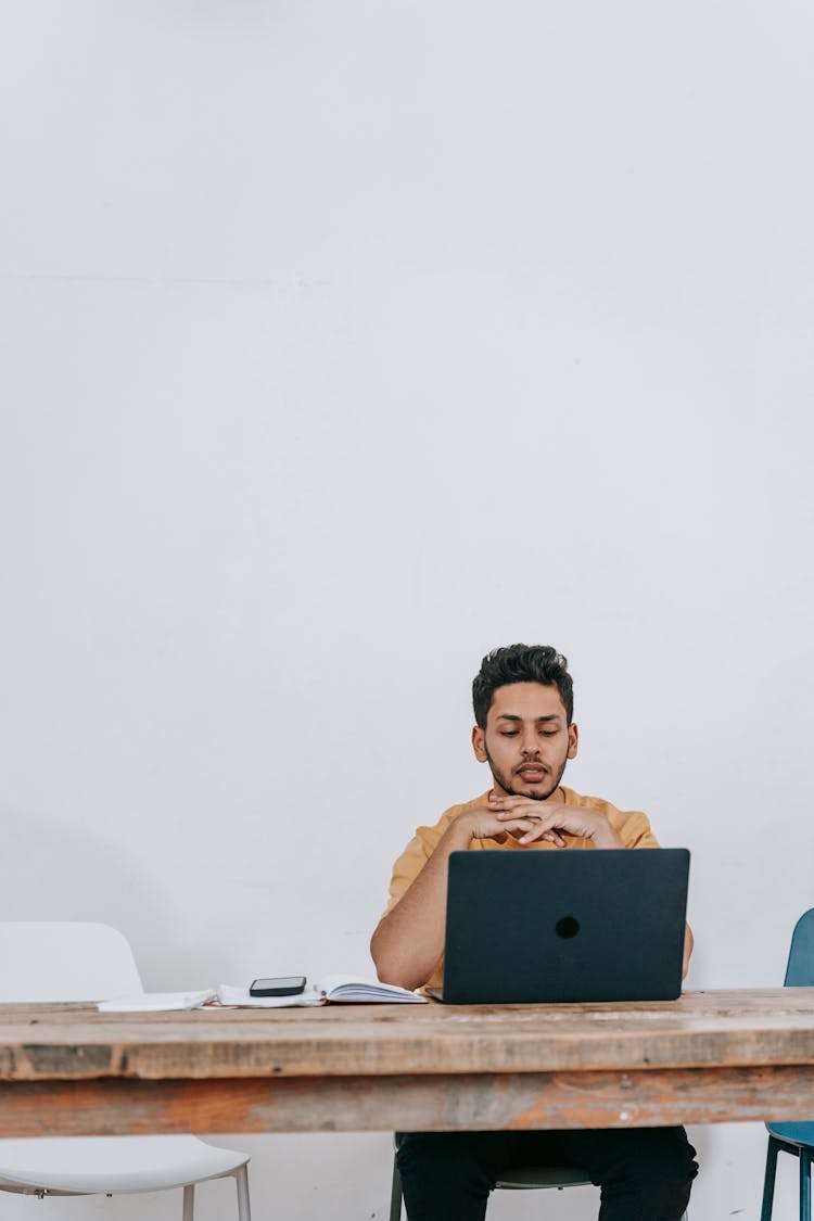 Focused Man Working Online On Laptop