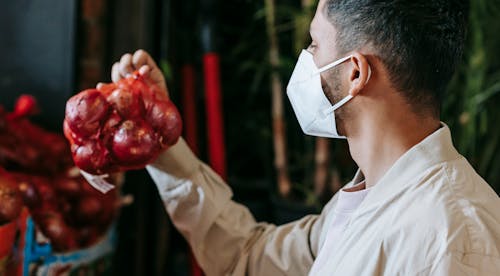 Man in mask choosing grocery in store