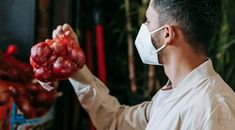 Man in mask choosing grocery in store