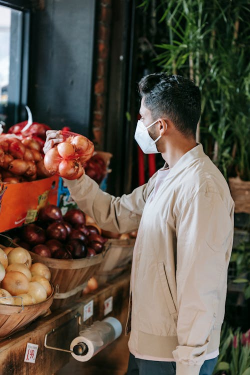 Ethnic man choosing goods in grocery market