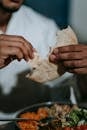 Person in White Dress Shirt Holding White Bread