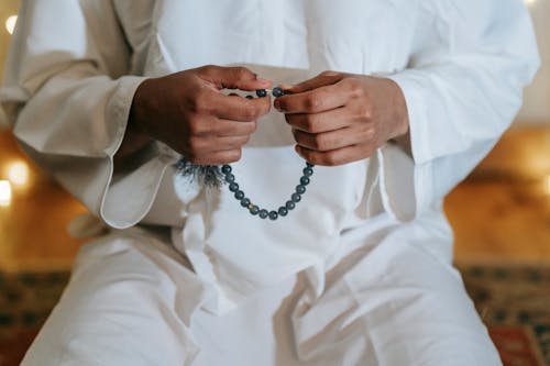 Person in White Thobe Praying