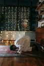 Man in White Thobe Bowing Down on Red and Blue Rug