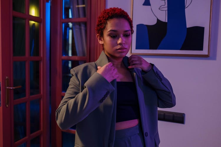 Young Woman Getting Ready And Putting On A Blazer 