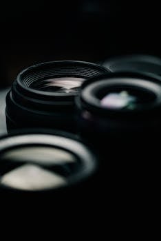 Artistic close-up of camera lenses with a shallow depth of field creating a moody atmosphere.