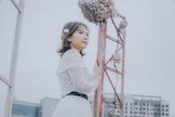 A Low Angle Shot of a Woman in White Off Shoulder Top