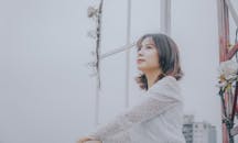 A Low Angle Shot of a Woman Wearing a White Long Sleeves