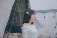 A Woman in White Lace Off Shoulder Top Smiling