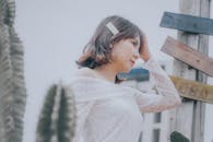 A Beautiful Woman with Her Hand on Her Head