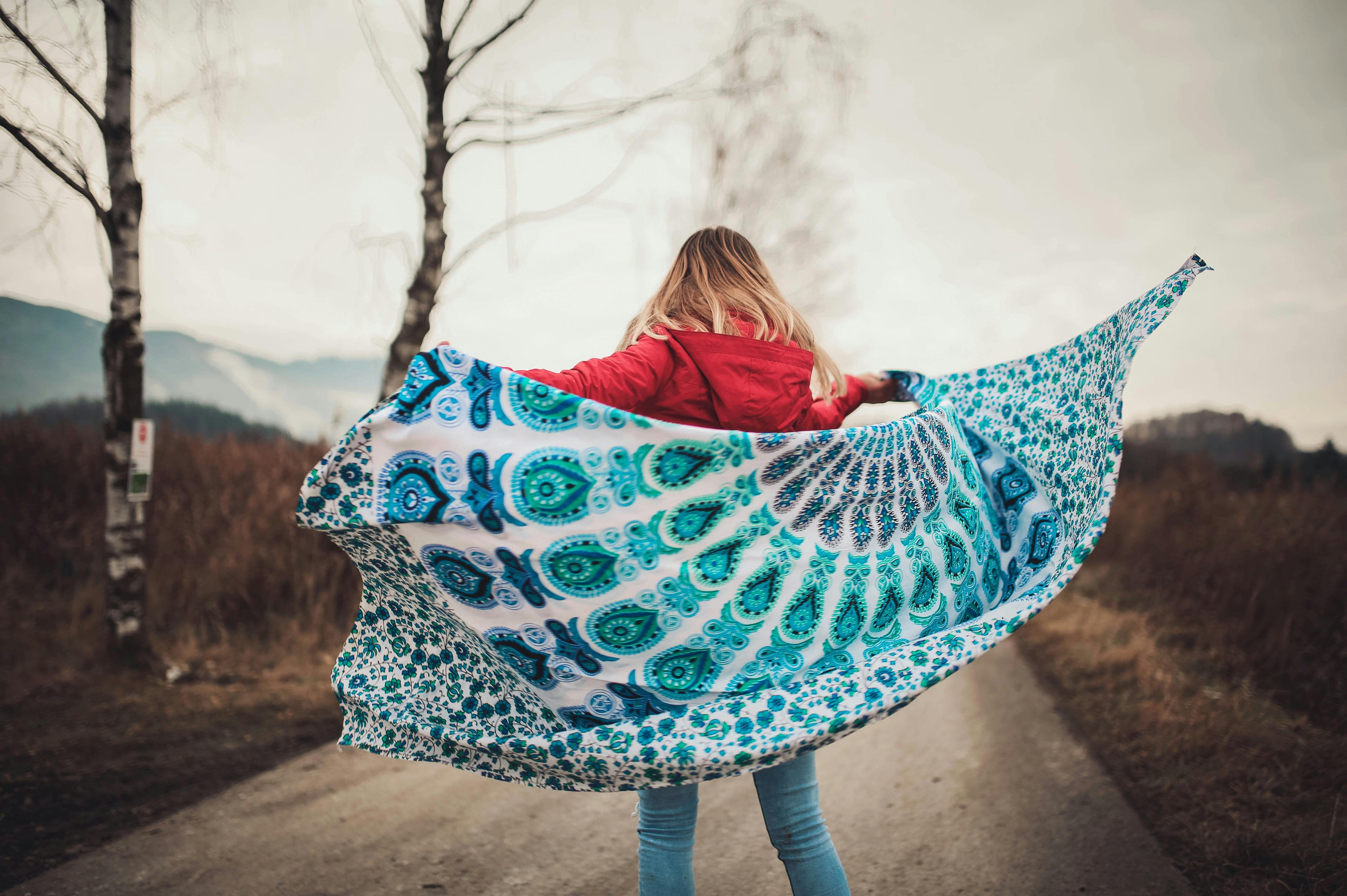 Woman Standing on the Middle of the Road Holding Blanket · Free Stock Photo