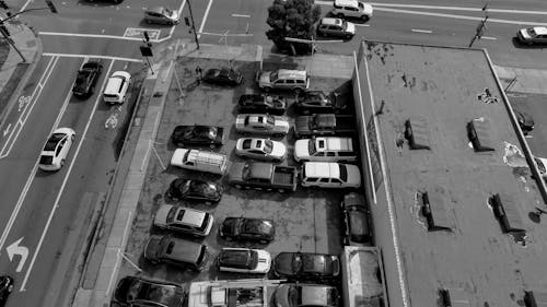 A Grayscale Photo of Cars Parked on a Parking Lot
