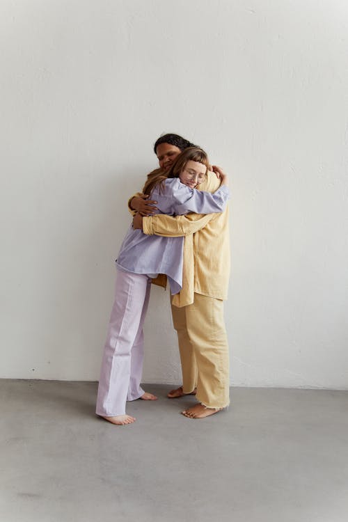 Photo of Women in Pajamas Hugging