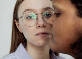 Close-up portrait of a diverse LGBTQ+ couple expressing intimate connection indoors.
