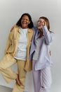 2 Women in White Blazer Standing Beside Each Other