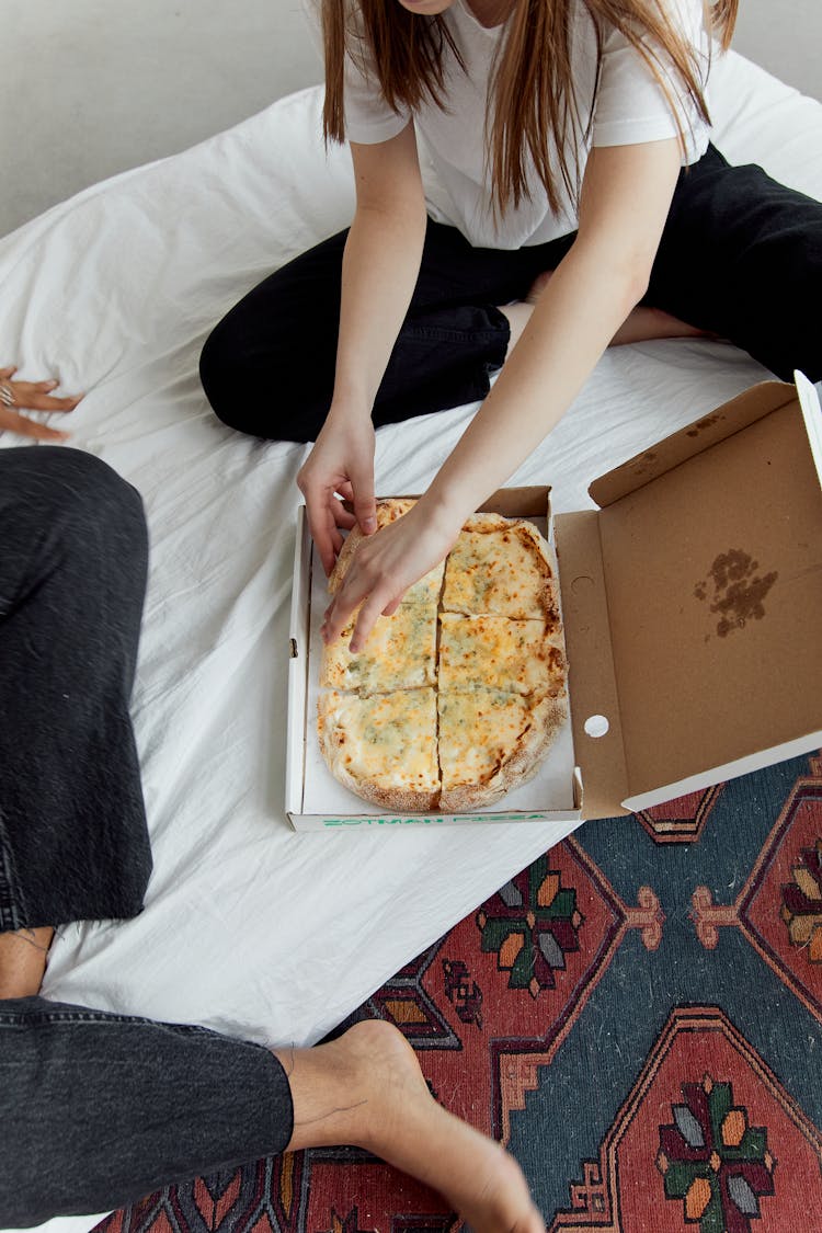 Woman Sitting Eating Pizza 