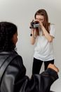 Woman in White Shirt Holding Black Smartphone
