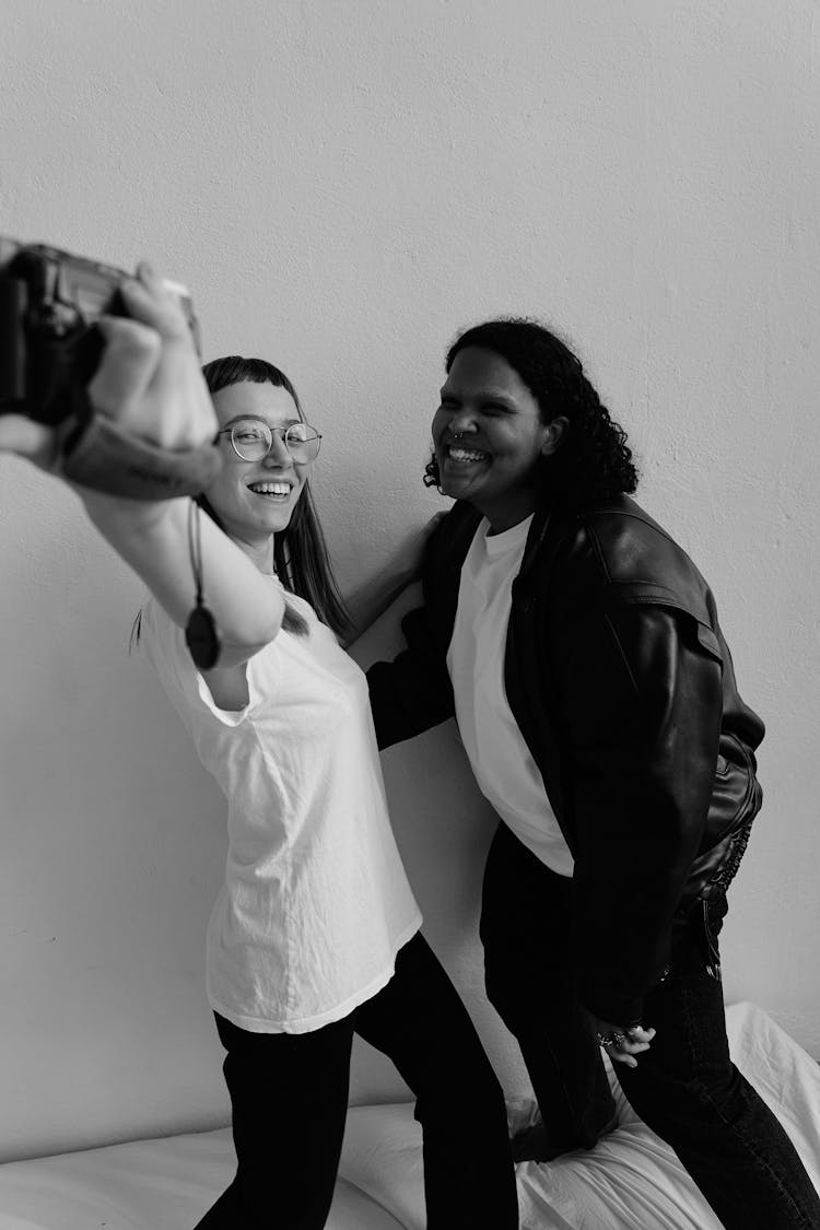 Two Women Smiling At A Video Recorder