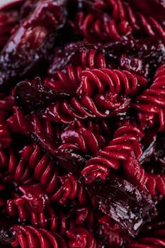 Close-up of vibrant red beet pasta highlighting its rich texture and color. Perfect for culinary enthusiasts.