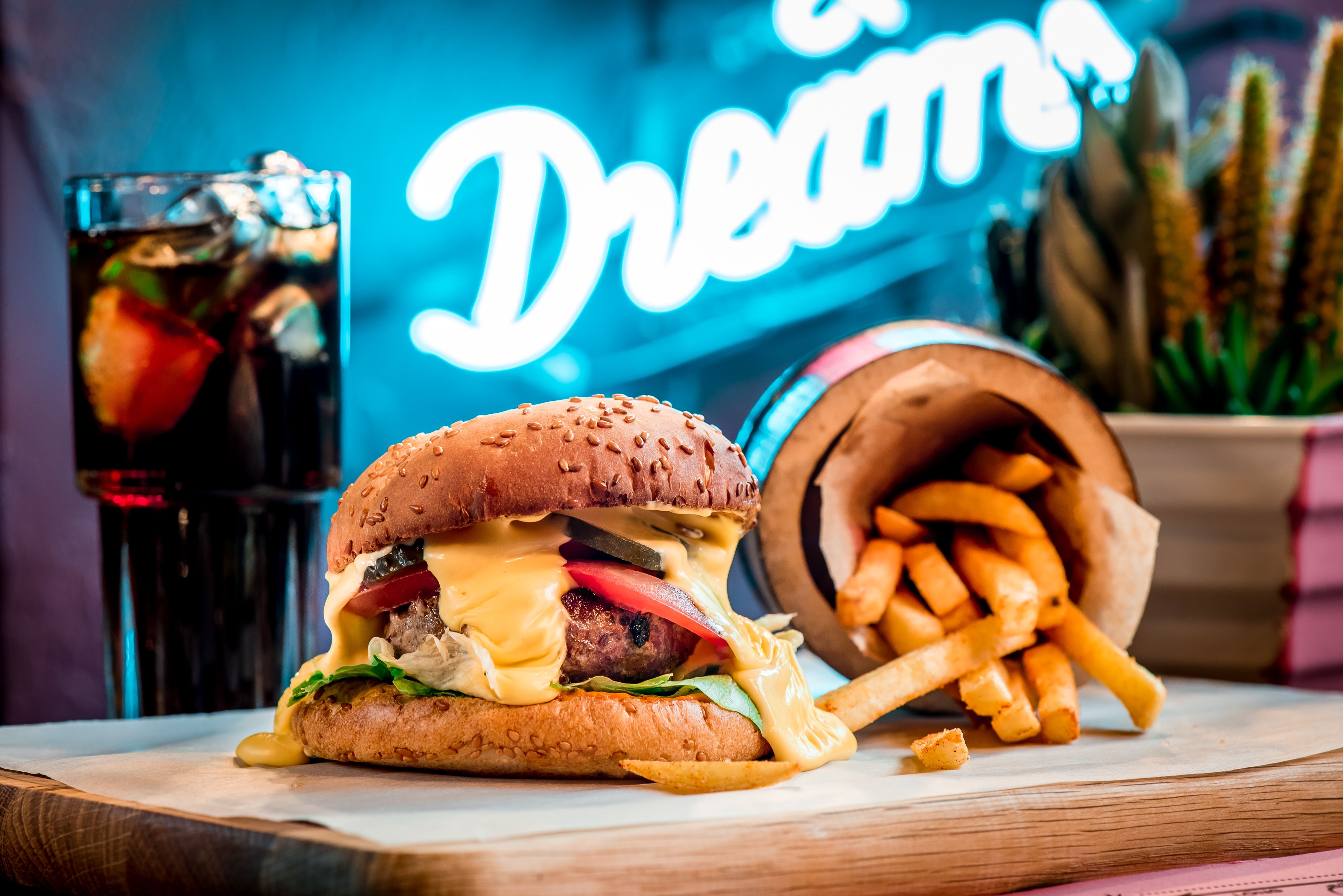 Delicious cheeseburger with fries and soda in a vibrant diner setting. Perfect fast food meal.