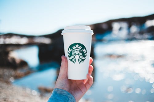 Free A Person Holding a Starbucks Cup Stock Photo