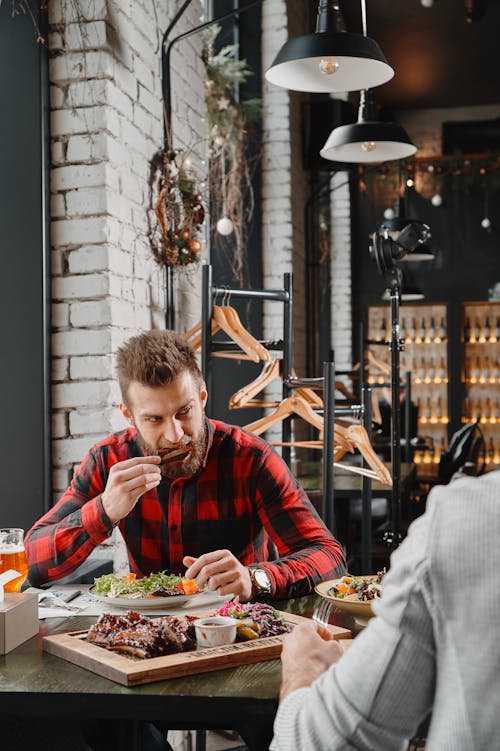 Photo of a Man Eating Ribs