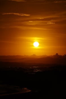 Stunning sunset over the ocean in Punta del Este, creating silhouettes and warm hues.