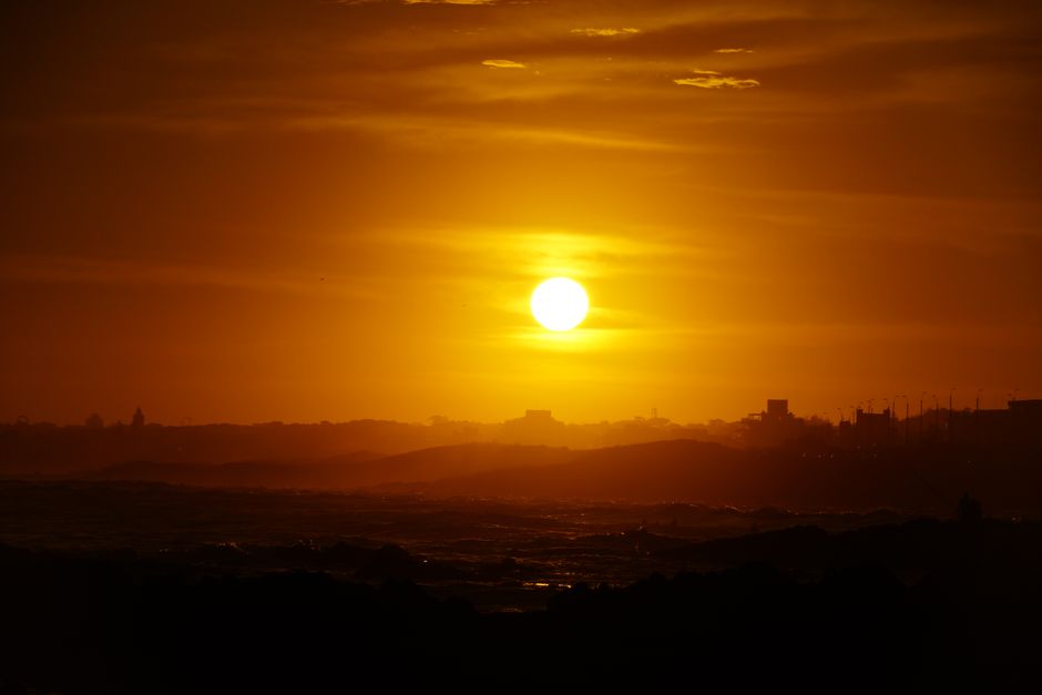 Golden sunset casting silhouettes across the ocean at Punta del Este, Uruguay.