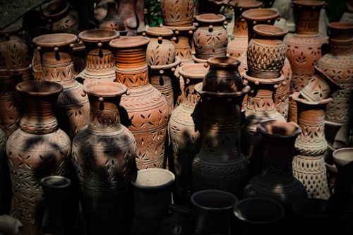 Free Collection of intricately designed terracotta vases displayed outdoors in natural light. Stock Photo